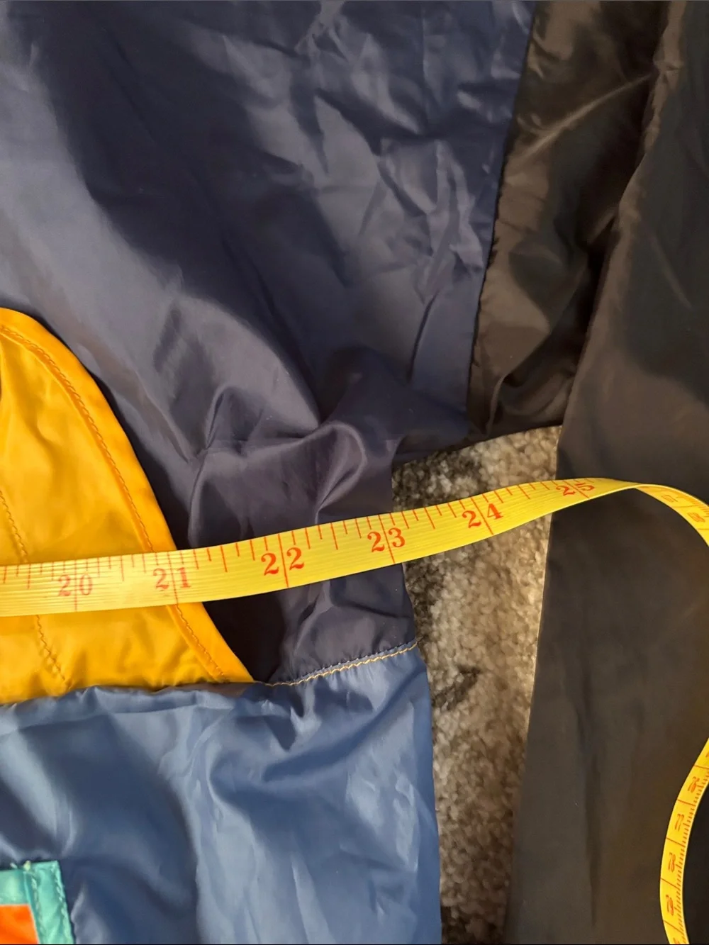 cotopaxi Navy Windbreaker with Orange and Yellow Colorblock